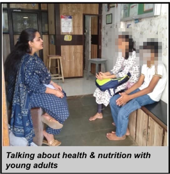 An IEC counsellor in conversation with a young person and the family member accompanying them at the OPD, both their faces redacted