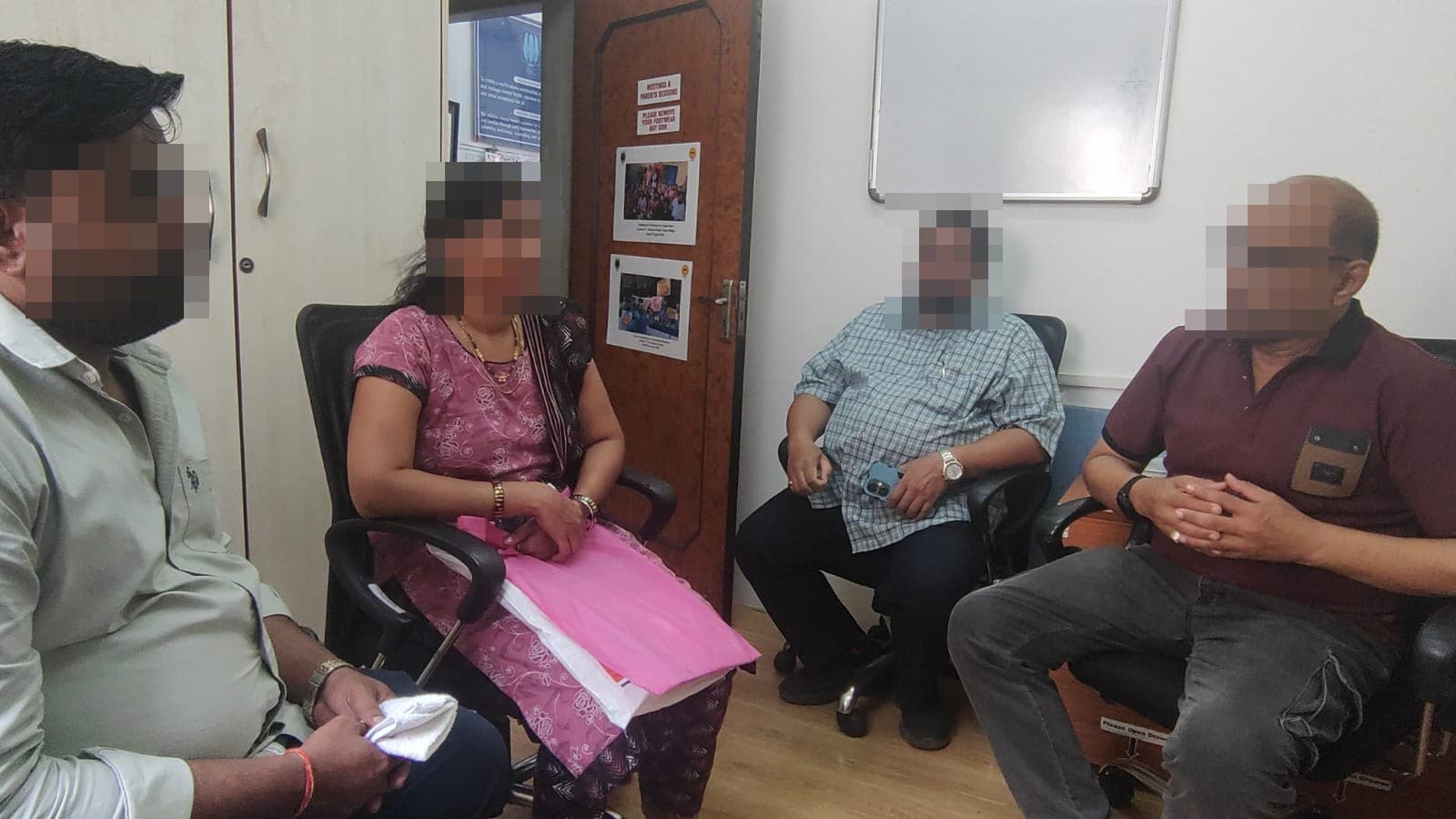 Reliable Charitable Trust members in discussion with the IEC team, every face in the room redacted