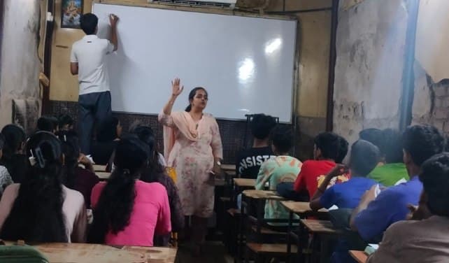 An IEC facilitator leading a session at the coaching class in Tunga Gaon