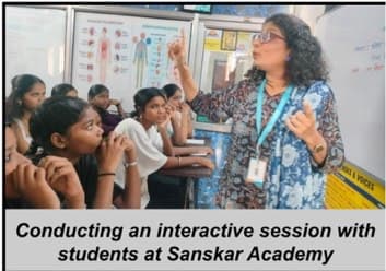 Students gathered around an IEC facilitator at Sanskar Academy