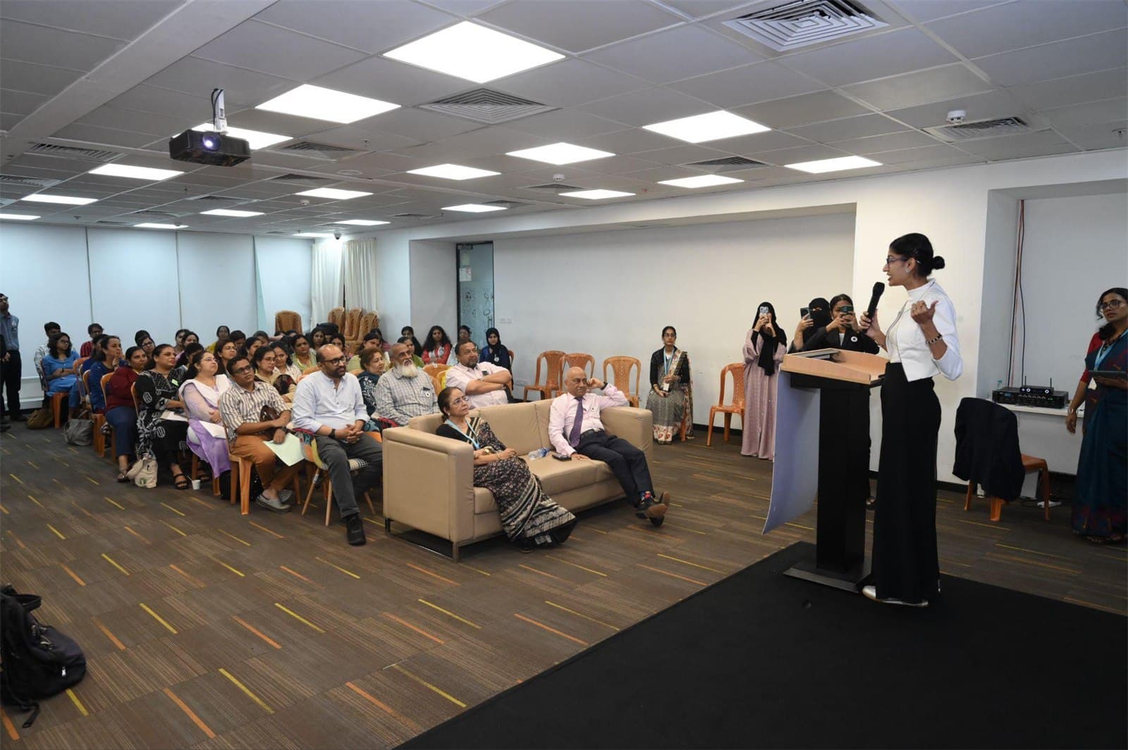 A speaker addressing principals, educators and counsellors at the summit