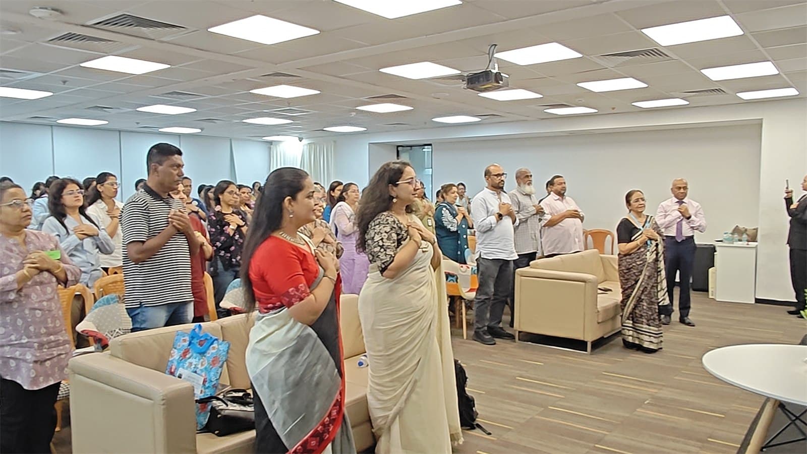 Summit participants standing together at the close of the session